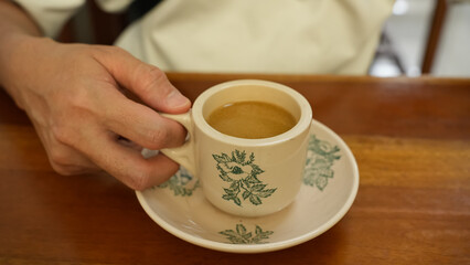 Man holding coffee cup at cafetaria