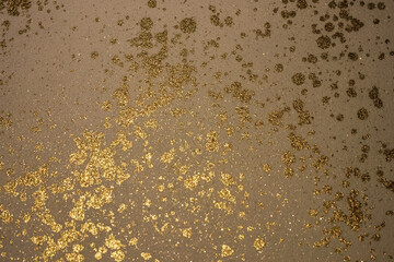 Golden Shimmer on Dark Textured Surface