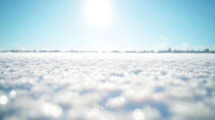 Bright sunlight intensely reflecting off a vast, snow covered field under a clear blue sky
