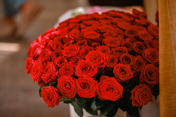 An impressive and abundant bouquet featuring countless vibrant crimson red roses for romance