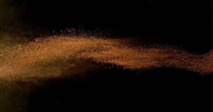 Flying Orange Clay Powder. Abstract Linear Dust Flow in Super Slow Motion. 1000fps. Isolated on Black Background. Tennis Themed Design Element for Dynamic Visuals