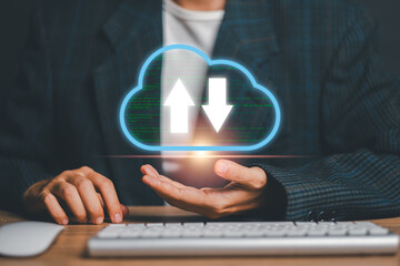 Businessman in suit holding a digital cloud icon with data transfer arrows, symbolizing cloud computing and data management.