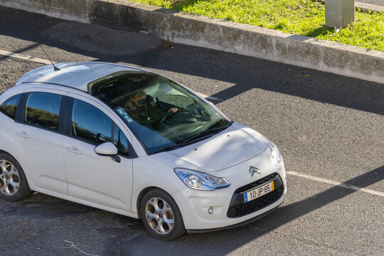 White citroen c3 car driving on asphalt road
