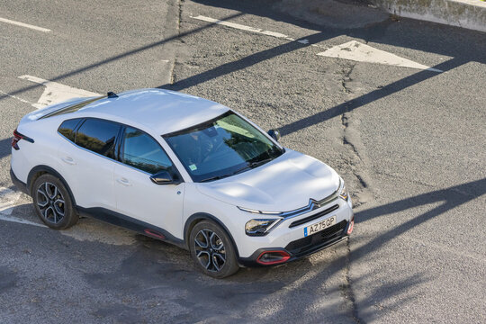 White citroen c4 x compact car driving on urban road