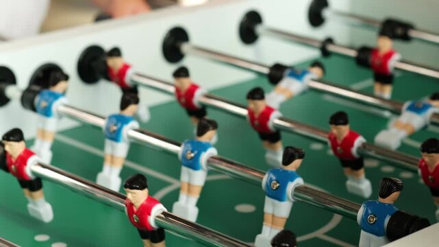 close-up of a table football game. table football playing field, table games competition red and blue teams.