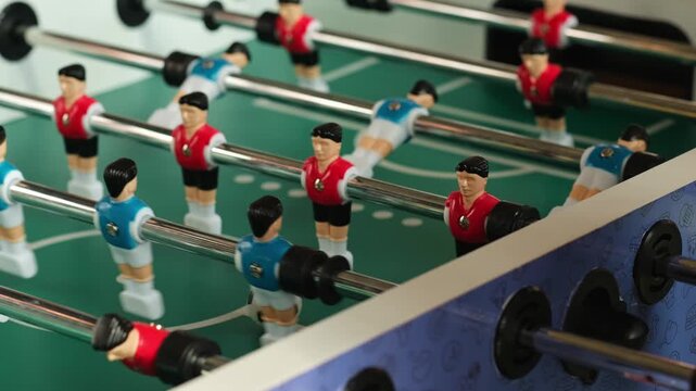 close-up of a table football game. table football playing field, table games competition red and blue teams.