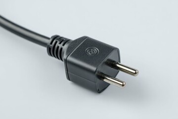 Close up of a black electrical plug with two metal prongs.