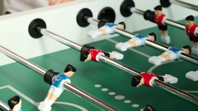 close-up of a table football game. table football playing field, table games competition red and blue teams.