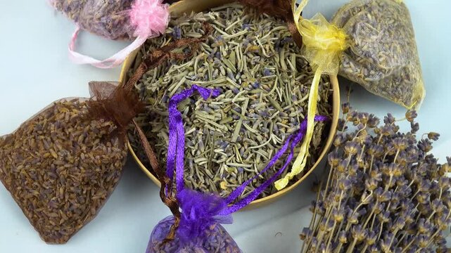 Dried lavender organza sachets filled with petals and buds lie on a table, top view