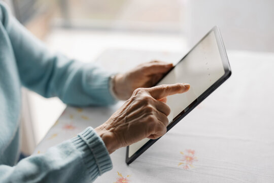 Senior woman using digital tablet at home
