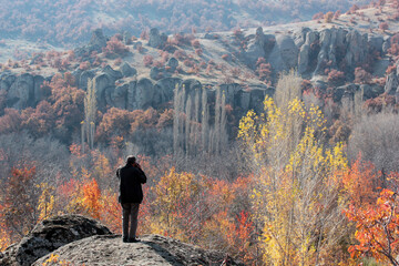 Photographer taking photos in nature in autumn