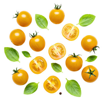Close-up flat lay: vibrant yellow cherry tomatoes (whole, halved with seeds) and bright green basil leaves scattered on a transparent. Fresh healthy food concept
