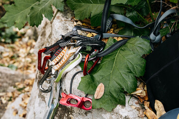 Traditional Rock Climbing Gear With Tube On Rock Surface: Quick Draws, Carabiners, And Tubular...