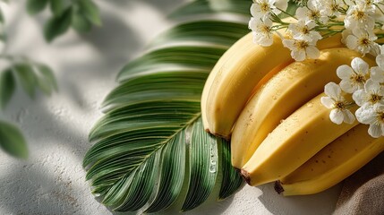Fresh Bananas with Green Leaf and White Flowers on Soft Background