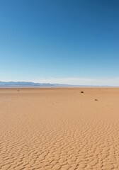 Vast, empty desert landscape under a clear sky. The flat, unbroken horizon emphasizes solitude and the immense scale of the scene and atmosphere, remote, simplicity, calm