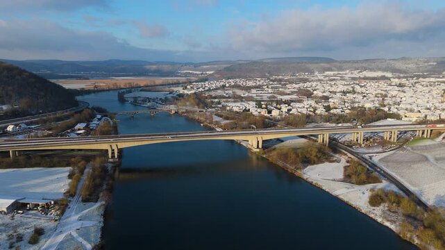 Snow covered Moselle valley, vineyard and Mosel river, Viaduct Longuich bridge of highway crossing near Trier, aerial view, winter season with frost in Germany