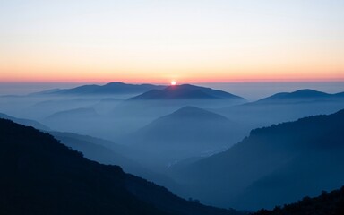 Misty mountain range at sunrise with sun peeking over the horizon mountains dawn