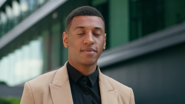 Thoughtful African American business man thinking looking at camera in city outdoors near office building pensive entrepreneur realtor employer male guy urban businessman confident corporate portrait