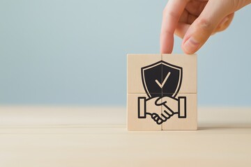 A conceptual image depicting a hand placing a wooden block with a security shield and handshake symbol representing trust and protection