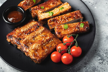 Closeup of pork ribs grilled with BBQ sauce and caramelized in honey.