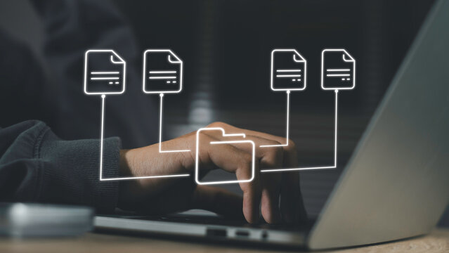 Hand on laptop keyboard with glowing folder and document icons, representing automated digital file management, efficient data organization, and smart document control in modern workspaces. - Powered by Adobe