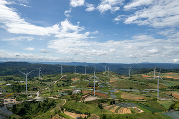 Wind turbines on Khao Kho mountain in Phetchabun, Thailand &mdash; renewable energy farm with scenic landscape and cloudy sky.