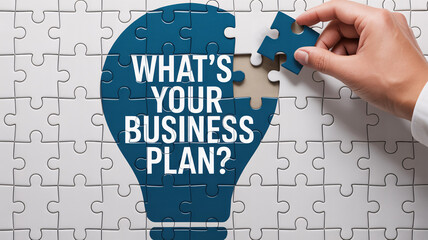Hand completing puzzle lightbulb with "WHAT'S YOUR BUSINESS PLAN?" text on white background