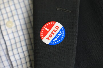 Close-up of I voted sticker on business suit