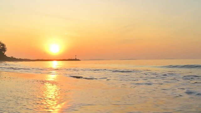 Golden Hour Seaside Serenity: The radiant sun casts a golden glow over a tranquil seascape, as gentle waves caress the shore, creating a scene of absolute peace and serenity.