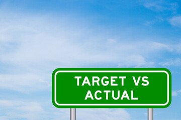 Green color transportation sign with word target vs actual on blue sky with white cloud background