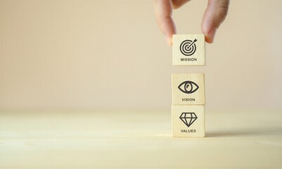 Hand holding wooden blocks with mission vision and values icons