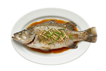 Steamed whole fish with ginger and soy sauce isolated. Festive seafood dish.