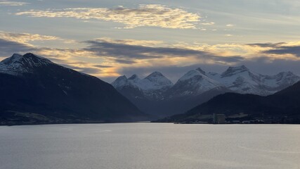 Winter Photo of Norwegian Fjord in &Aring;lesund with Snowy Mountains in the Background