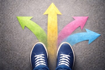 person standing on road with multiple colorful arrows pointing upwards  choosing different paths
