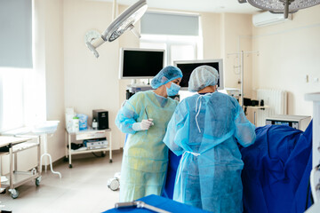 Female nurses handling sterile surgical linens during operating room preparation