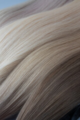 Close-up view of luxurious blonde and brunette hair strands in varying shades