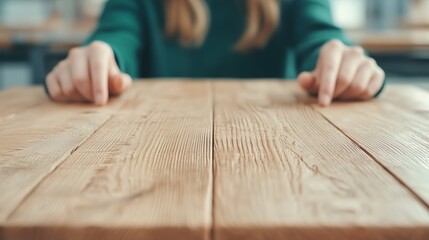 Close-up View of Human Hands Pointing at a Wooden Table Surface in a Bright and Minimalist Setting