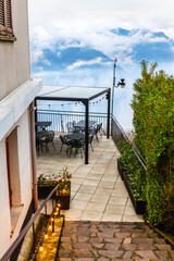 Morning fog at Como lake, Italy. Cafe on the terrace overlooking Alps mountains and lake Como