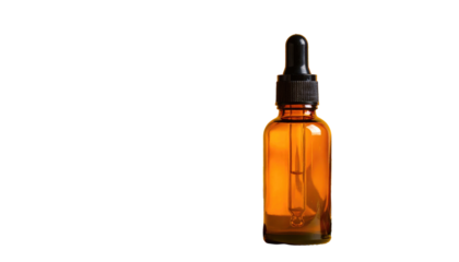 Amber glass dropper bottle, filled, right side, on black background, for beauty or wellness product photo