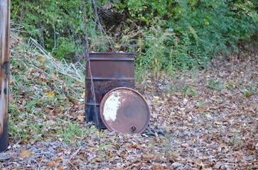 old rusty burning barrel with lide
