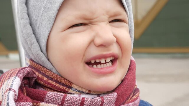 Close-up of an angry impudent boy swearing outdoors