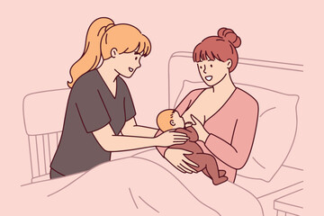 Professional midwife or nurse helps a new mother learn the correct breastfeeding position for her baby girl. Education and support for lactation and infant care in the maternity ward.