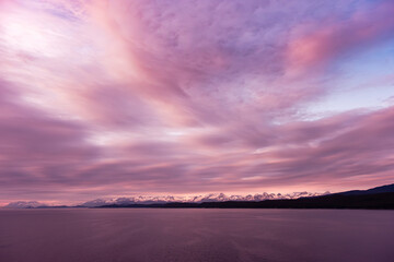 Fioery susnset over Alaskan mountains and Pacific Ocean