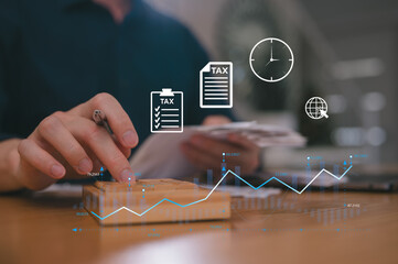 Businessman hand using calculator to budgeting and tax calculation monthly expenses. budget management and accounting on table. Business finance accounting banking concept.