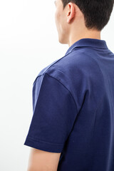 Side view of man in navy blue polo shirt on white background