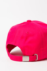 Close-up of pink baseball cap from behind at angle on white background