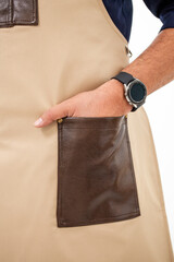 Close-up of beige apron pocket with mans hand and smartwatch