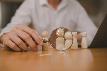 Businessman career manager holding magnifying glass focus on wood peg looking for employees or candidates, HR recruiting, isometric managers looking at each businessman with a magnifying glass