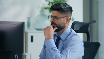 Concentrated Muslim man Arabian business male worker Indian productive businessman guy working with computer check data analyze online data information review expertise financial job result with pc