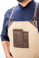Man wearing beige apron with brown leather accents and pocket on white background